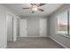 An open bedroom with two white doors and a large window at 9734 W Carol Ave, Peoria, AZ 85345