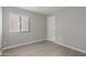 Bedroom with a window, white trim and a single white door at 9734 W Carol Ave, Peoria, AZ 85345