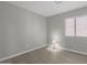 A gray bedroom with a window and hardwood floors at 9734 W Carol Ave, Peoria, AZ 85345