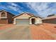 Single-story home with a large garage and driveway at 9734 W Carol Ave, Peoria, AZ 85345