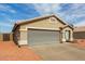 Single-story home with a large garage and desert landscaping at 9734 W Carol Ave, Peoria, AZ 85345