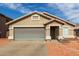 Single-story home with a large garage and desert landscaping at 9734 W Carol Ave, Peoria, AZ 85345