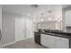 Kitchen featuring white cabinets, dark countertops, stainless steel appliances, and wood-look floors at 9734 W Carol Ave, Peoria, AZ 85345