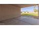 Covered patio with concrete flooring leads to a gravel and stone landscaped backyard at 9734 W Carol Ave, Peoria, AZ 85345