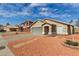 This home has a desert landscape, large driveway, and well-manicured lawn at 9734 W Carol Ave, Peoria, AZ 85345