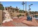 Scenic backyard featuring a brick patio, lake access, and relaxing Adirondack chairs at 10243 N 103Rd St, Scottsdale, AZ 85258