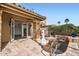 Outdoor patio with stone pillars, tiled flooring, in ground spa, open doors to living space at 10243 N 103Rd St, Scottsdale, AZ 85258