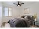 Staged bedroom featuring wood floors, white walls, ceiling fan, window, and neutral-toned bedding at 10243 N 103Rd St, Scottsdale, AZ 85258