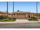 Charming home with a well-manicured lawn, a two-car garage, and a beautiful desert landscape at 10243 N 103Rd St, Scottsdale, AZ 85258