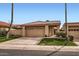 Inviting home featuring a two-car garage, desert landscaping, and a tile roof at 10243 N 103Rd St, Scottsdale, AZ 85258