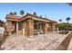 Exterior view of patio and spa area with stone accents, tiled roofing, and paved patio at 10243 N 103Rd St, Scottsdale, AZ 85258