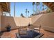 Private patio area with tiled flooring, decorated with a table, seating and potted plants at 10243 N 103Rd St, Scottsdale, AZ 85258