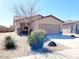 Charming single-story home with a tile roof and a well-maintained front yard with desert landscaping at 1061 W Palo Verde Ave, Coolidge, AZ 85128