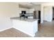 A modern kitchen showcasing white cabinets, stainless steel appliances, and a breakfast bar with granite countertop at 1061 W Palo Verde Ave, Coolidge, AZ 85128