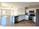 A modern kitchen featuring stainless steel appliances, granite countertops, and a spacious layout at 1061 W Palo Verde Ave, Coolidge, AZ 85128