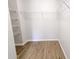 Walk-in closet with shelving and wood floor at 1061 W Palo Verde Ave, Coolidge, AZ 85128