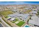 Expansive aerial view showcases home with lush backyard featuring a modern firepit, patio, and outdoor kitchen at 10635 E Tesla Ave, Mesa, AZ 85212