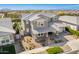 Aerial view of a two-story home with a well-manicured yard in a suburban neighborhood at 10635 E Tesla Ave, Mesa, AZ 85212