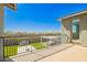 View from a balcony overlooking a well-maintained yard with artificial grass and a desert landscape at 10635 E Tesla Ave, Mesa, AZ 85212