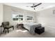 Inviting bedroom with a large window, soft lighting, and stylish accent chair, creating a warm retreat at 10635 E Tesla Ave, Mesa, AZ 85212