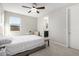 Comfortable bedroom featuring neutral tones, a ceiling fan, and a bright window with mountain views at 10635 E Tesla Ave, Mesa, AZ 85212