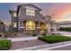 Beautiful two-story home with well-maintained landscaping and inviting curb appeal at sunset at 10635 E Tesla Ave, Mesa, AZ 85212