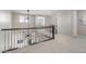 Upstairs hallway features modern railings and a view of downstairs at 10635 E Tesla Ave, Mesa, AZ 85212