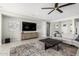 Cozy living room with a stylish rug, TV, and a comfortable couch for relaxing at 10635 E Tesla Ave, Mesa, AZ 85212