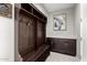 Well-organized mudroom with custom shelving, bench seating, and cabinet storage at 10635 E Tesla Ave, Mesa, AZ 85212