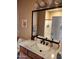 Bathroom features a sleek marble vanity, a modern black faucet, and a shower behind a white door at 10655 N 9Th St # 204, Phoenix, AZ 85020