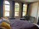 Comfortable bedroom featuring arched windows, stylish curtains, and a functional workspace at 10655 N 9Th St # 204, Phoenix, AZ 85020