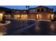 A street view of townhomes with attached garages and desert landscaping at nighttime at 10655 N 9Th St # 204, Phoenix, AZ 85020