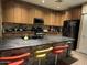 Kitchen island with modern countertops, wood cabinets, and bar stool seating at 10655 N 9Th St # 204, Phoenix, AZ 85020