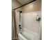 Modern shower featuring sleek white tiles, a rainfall showerhead, and a convenient shampoo niche at 10655 N 9Th St # 204, Phoenix, AZ 85020