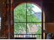 Lovely view of mountains, foliage, and neighborhood through an arched window at 10655 N 9Th St # 204, Phoenix, AZ 85020