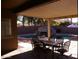 Covered patio with outdoor seating and a refreshing pool featuring a rock waterfall and slide at 1083 E Jade Dr, Chandler, AZ 85286