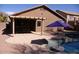 Inviting backyard pool area with umbrella and a covered patio for outdoor relaxation at 1083 E Jade Dr, Chandler, AZ 85286