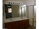 Bathroom features double sinks, wood cabinets, and a separate shower, with a glimpse into the bedroom through the mirror at 1083 E Jade Dr, Chandler, AZ 85286