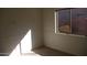 Bright bedroom with neutral carpet, fresh white paint, and a sunlit window at 1083 E Jade Dr, Chandler, AZ 85286