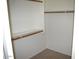 Bright walk-in closet with wooden rods and shelving offering ample storage space at 1083 E Jade Dr, Chandler, AZ 85286