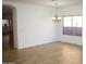 Bright dining area features tile flooring and a modern chandelier fixture at 1083 E Jade Dr, Chandler, AZ 85286