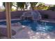 Backyard swimming pool features a stone waterfall and slide at 1083 E Jade Dr, Chandler, AZ 85286