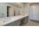 Bathroom with double sink vanity, granite counters, and decorative tile floor at 10972 N Hershey St, Surprise, AZ 85388