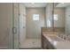 Sleek bathroom features glass enclosed shower, vanity with sink, and tile accents at 10972 N Hershey St, Surprise, AZ 85388