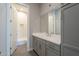 Spacious bathroom with a shower and bathtub, light gray cabinets and modern finishes at 10972 N Hershey St, Surprise, AZ 85388