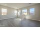 Bright bedroom with multiple windows and wood-look tile flooring offers a comfortable and stylish retreat at 10972 N Hershey St, Surprise, AZ 85388