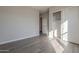 Light-filled bedroom with wood-look tile flooring and a closet with sliding doors at 10972 N Hershey St, Surprise, AZ 85388