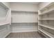 Large closet with light gray wood flooring and a combination of shelves and clothes racks at 10972 N Hershey St, Surprise, AZ 85388