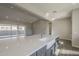 Bright and airy kitchen with a large island, stainless steel faucet, open layout, and hardwood flooring at 10972 N Hershey St, Surprise, AZ 85388