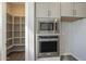 Pantry and stainless steel microwave and oven combination add convenience and functionality to this kitchen at 10972 N Hershey St, Surprise, AZ 85388